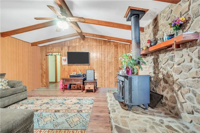 a kitchen with stainless steel appliances sink stove refrigerator dining table and chairs