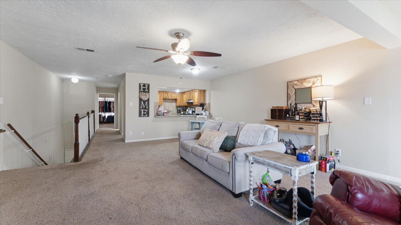 41 Regency Point Montgomery, TX 77356 - Photo 22 of 44 a living room with furniture and a chandelier