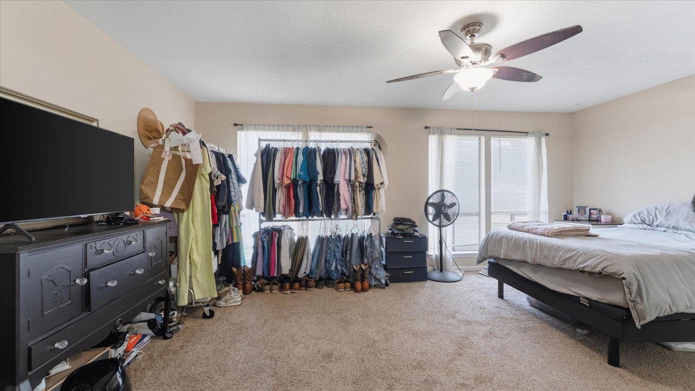 41 Regency Point Montgomery, TX 77356 - Photo 28 of 44 a bedroom with bed and a flat tv screen on dresser