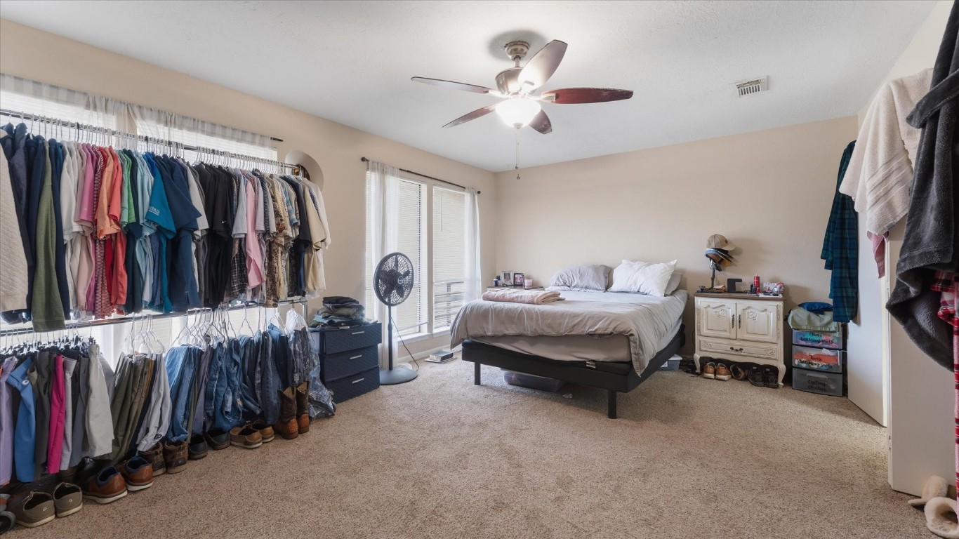 41 Regency Point Montgomery, TX 77356 - Photo 29 of 44 a spacious bedroom with a bed and a walk in closet