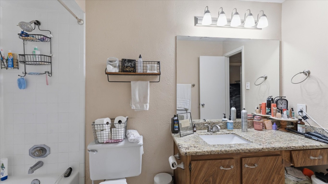 41 Regency Point Montgomery, TX 77356 - Photo 30 of 44 a bathroom with a granite countertop sink a mirror and shower