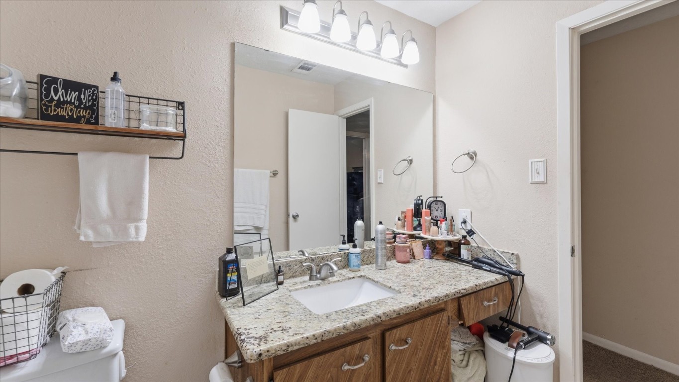 41 Regency Point Montgomery, TX 77356 - Photo 31 of 44 a bathroom with a granite countertop sink and a mirror