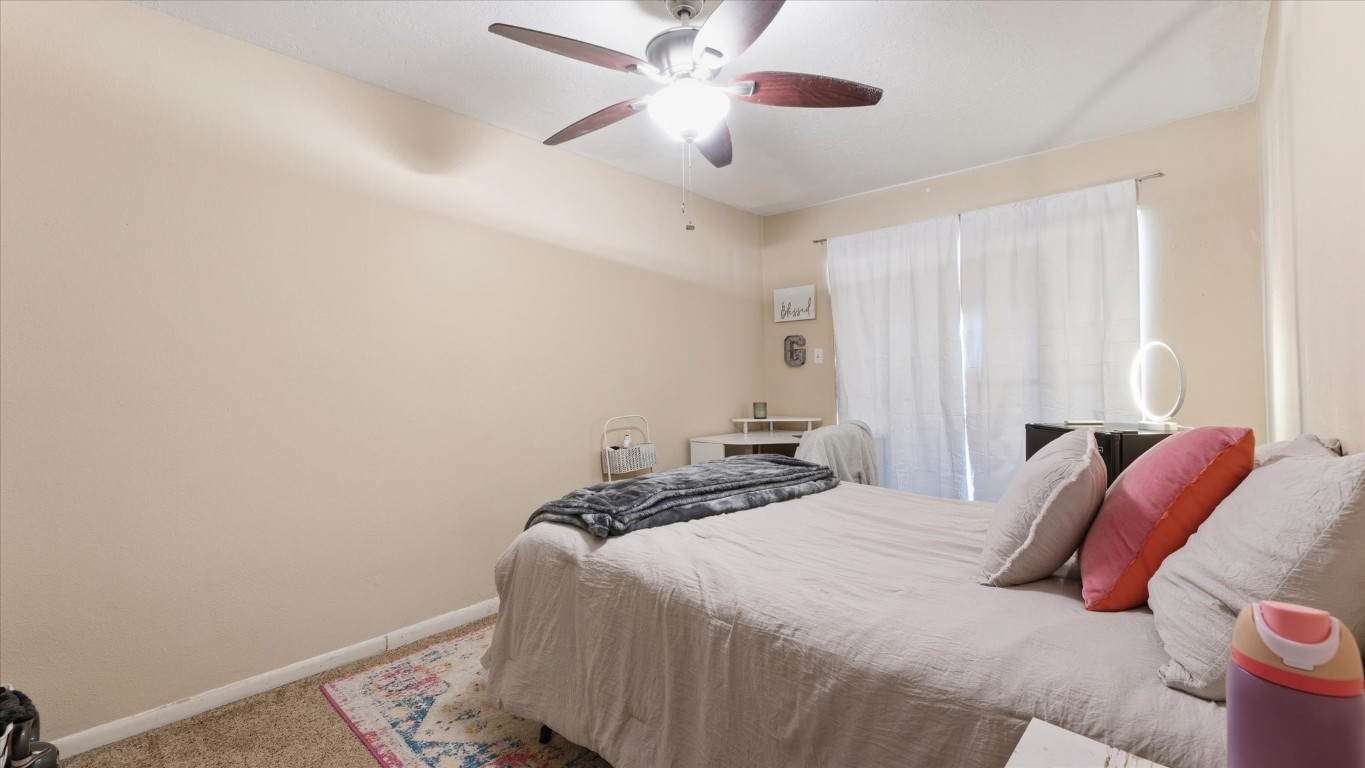 41 Regency Point Montgomery, TX 77356 - Photo 33 of 44 a bedroom with a bed and a ceiling fan