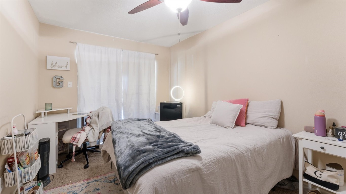 41 Regency Point Montgomery, TX 77356 - Photo 34 of 44 a bedroom with a bed and a chandelier