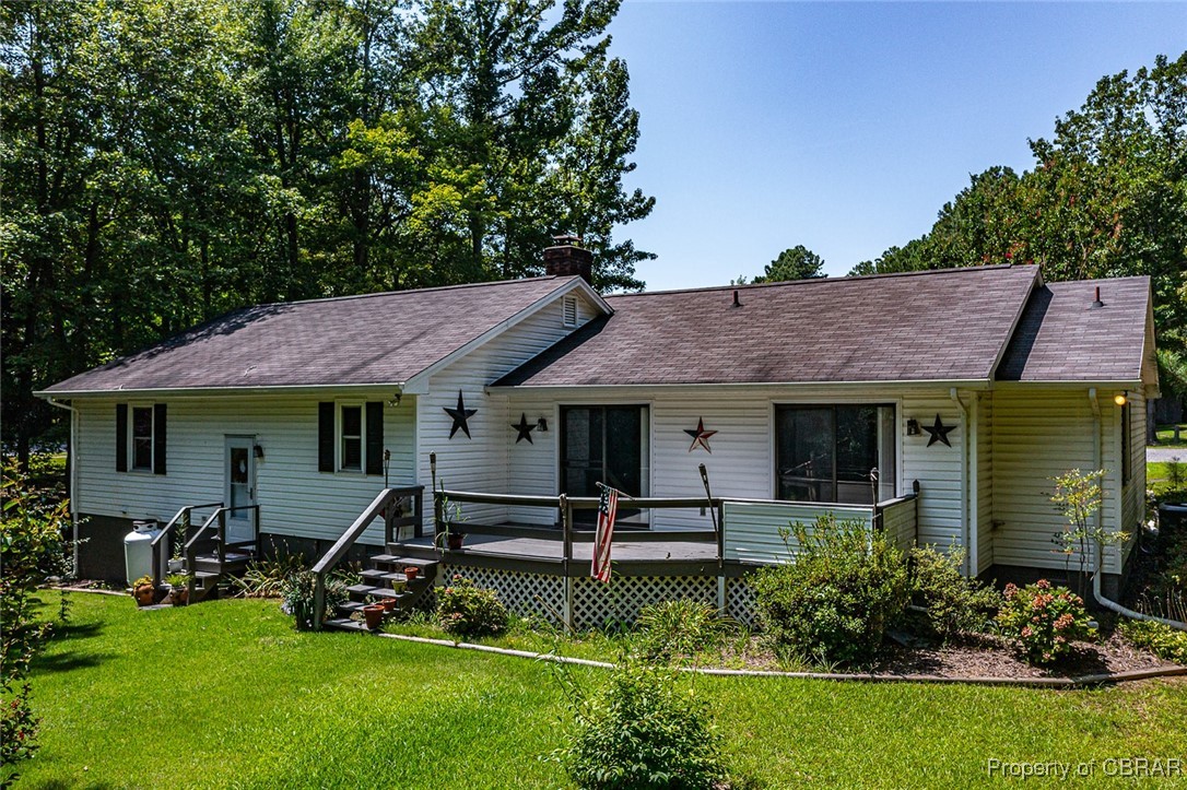 122 Old Glebe Point Road Burgess, VA 22432 - Photo 15 of 50 View of front of property featuring a wooden deck and a front lawn