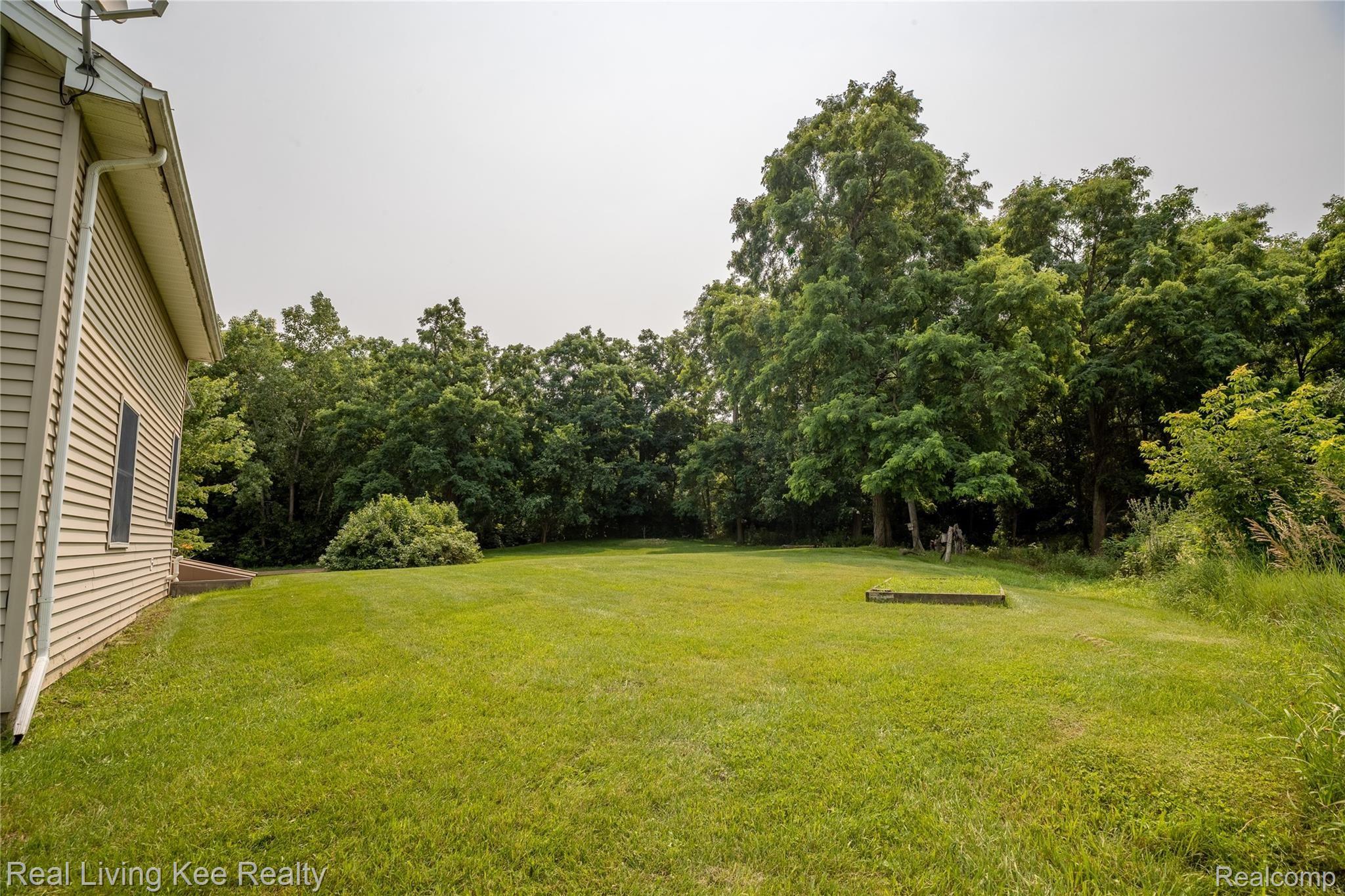 4230 Blood Road Metamora, MI 48455 - Photo 9 of 49 Lot includes expansive treed area on north side of home