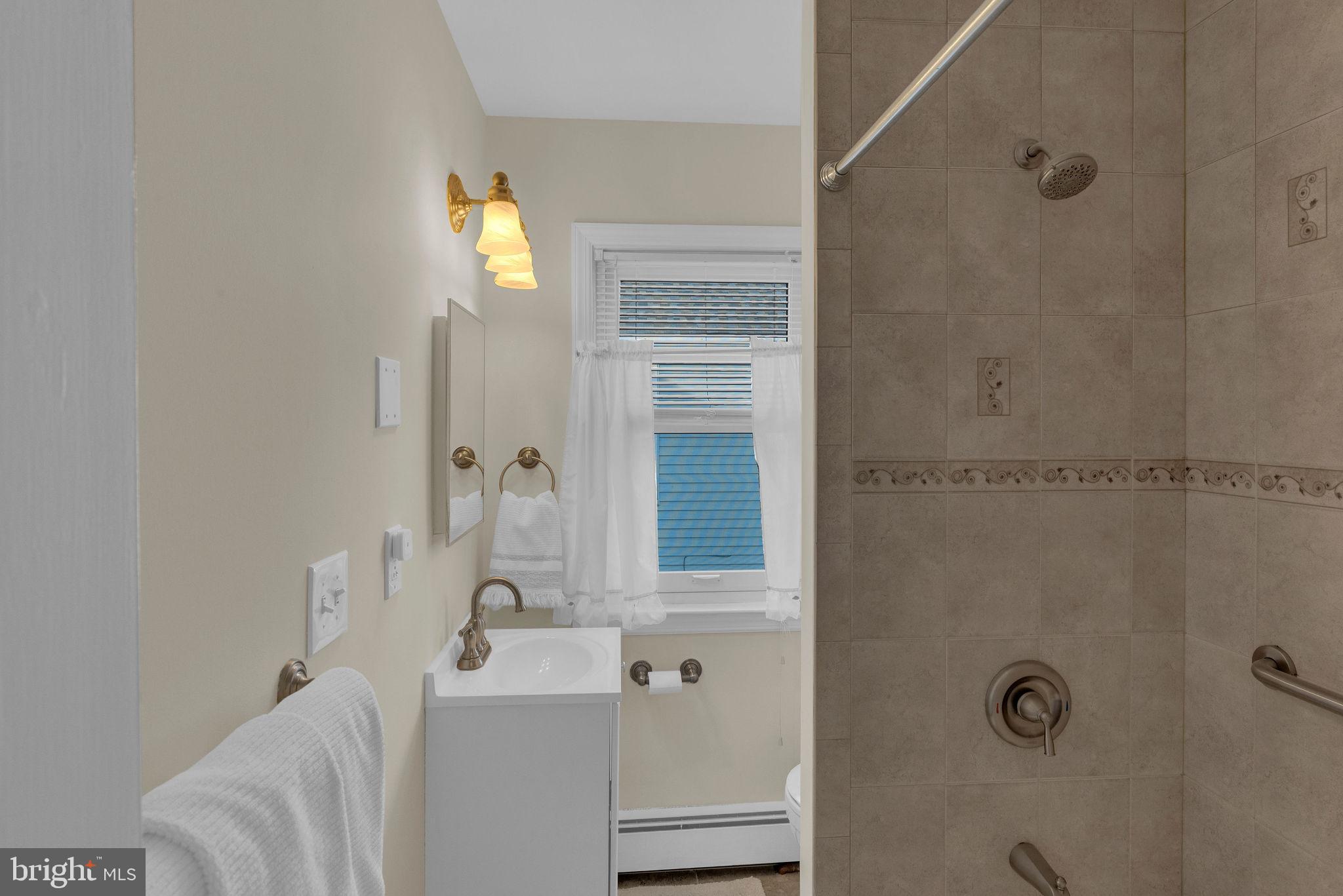 118 Hunter Avenue Hamilton, NJ 08610 - Photo 20 of 23 a bathroom with a sink and a mirror