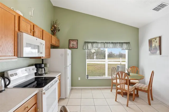 a kitchen that has a sink and a stove in it