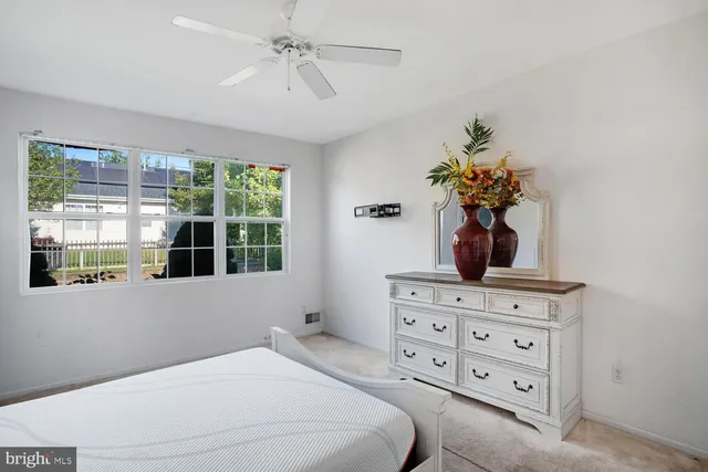 a bedroom with a bed dresser and a window