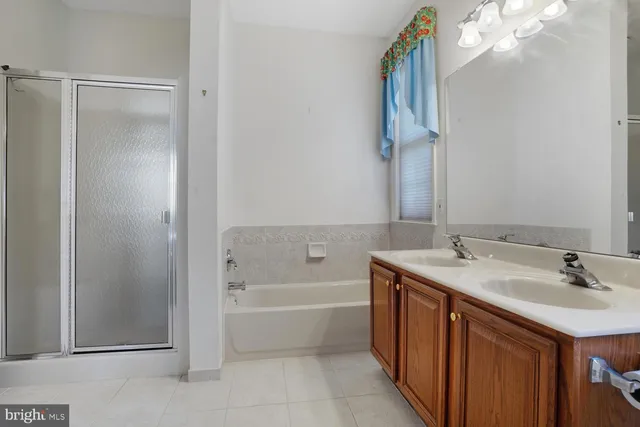a bathroom with a tub sink and mirror