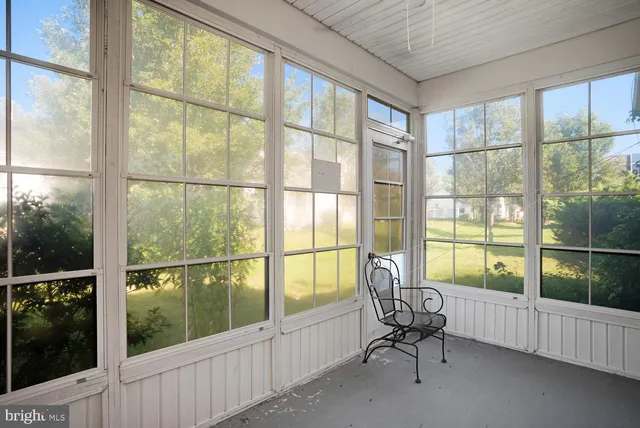 a living room with furniture and floor to ceiling windows