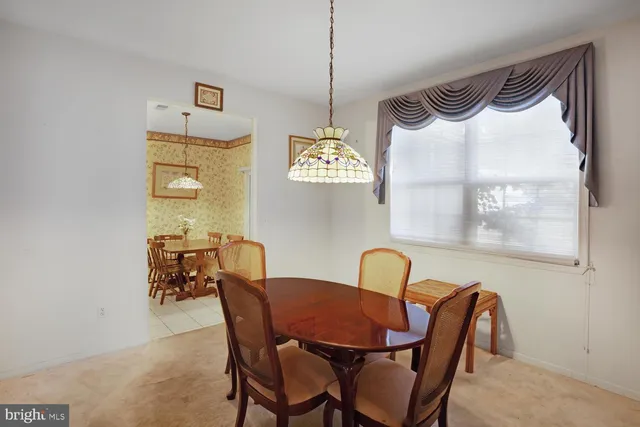a view of a dining room with furniture and a window