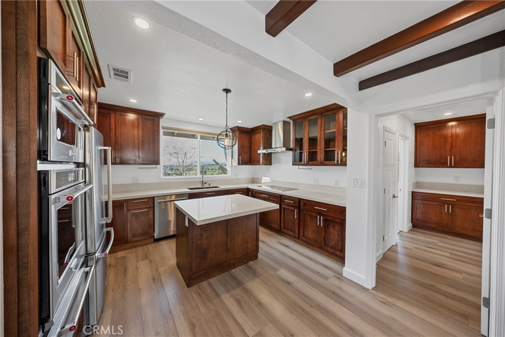 12646 10th Street Yucaipa, CA 92399 - Photo 15 of 72 a large kitchen with stainless steel appliances granite countertop a stove and a sink