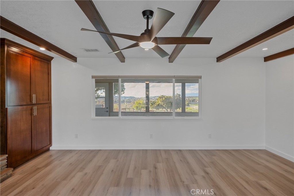 12646 10th Street Yucaipa, CA 92399 - Photo 19 of 72 a view of an empty room with wooden floor and a window