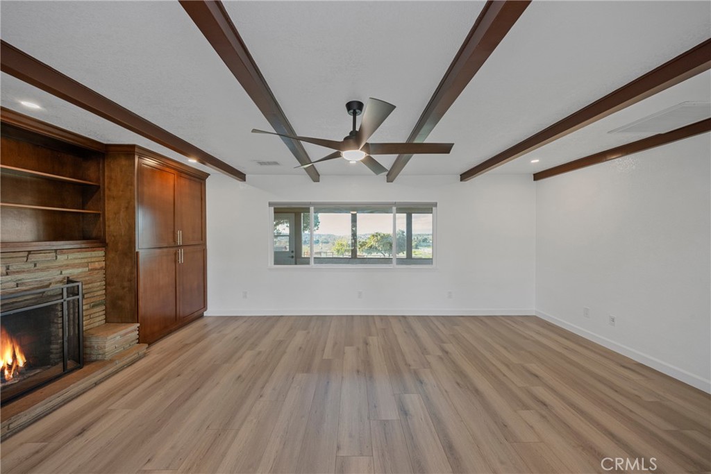 12646 10th Street Yucaipa, CA 92399 - Photo 20 of 72 a view of empty room with wooden floor and fireplace