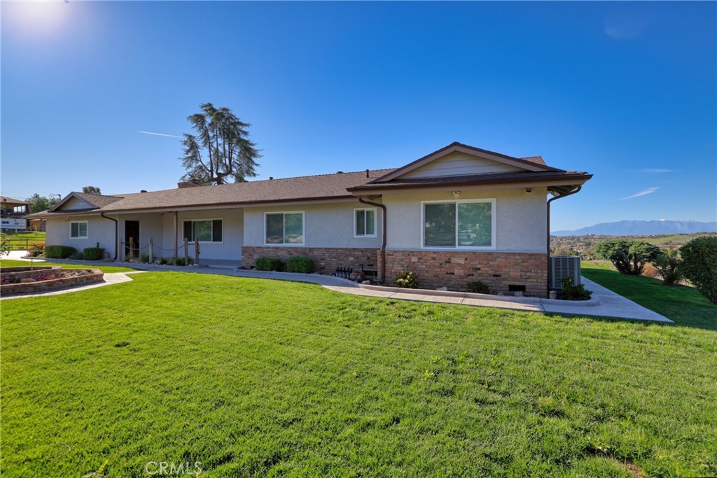 12646 10th Street Yucaipa, CA 92399 - Photo 2 of 72 a front view of a house with a garden