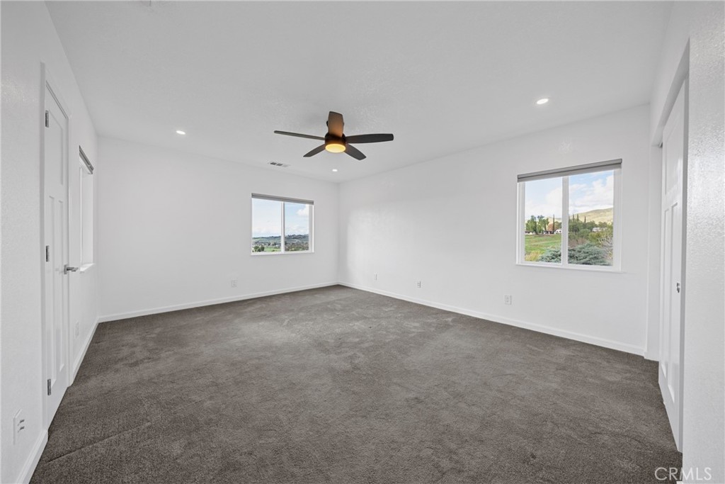 12646 10th Street Yucaipa, CA 92399 - Photo 21 of 72 a view of a livingroom with a ceiling fan and window