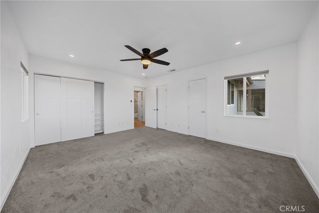 12646 10th Street Yucaipa, CA 92399 - Photo 23 of 72 a view of a livingroom with a ceiling fan and window