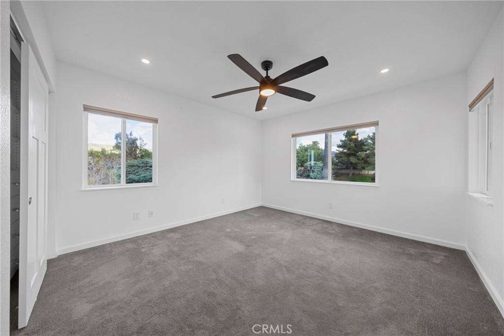 12646 10th Street Yucaipa, CA 92399 - Photo 25 of 72 an empty room with a window and a ceiling fan