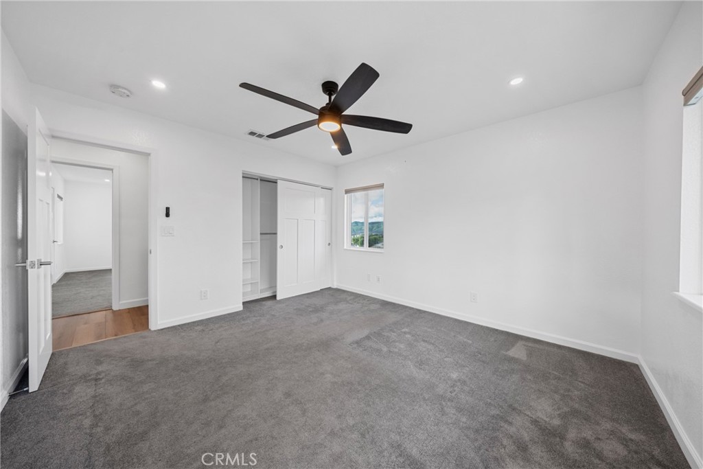 12646 10th Street Yucaipa, CA 92399 - Photo 26 of 72 a view of a livingroom with a ceiling fan and window