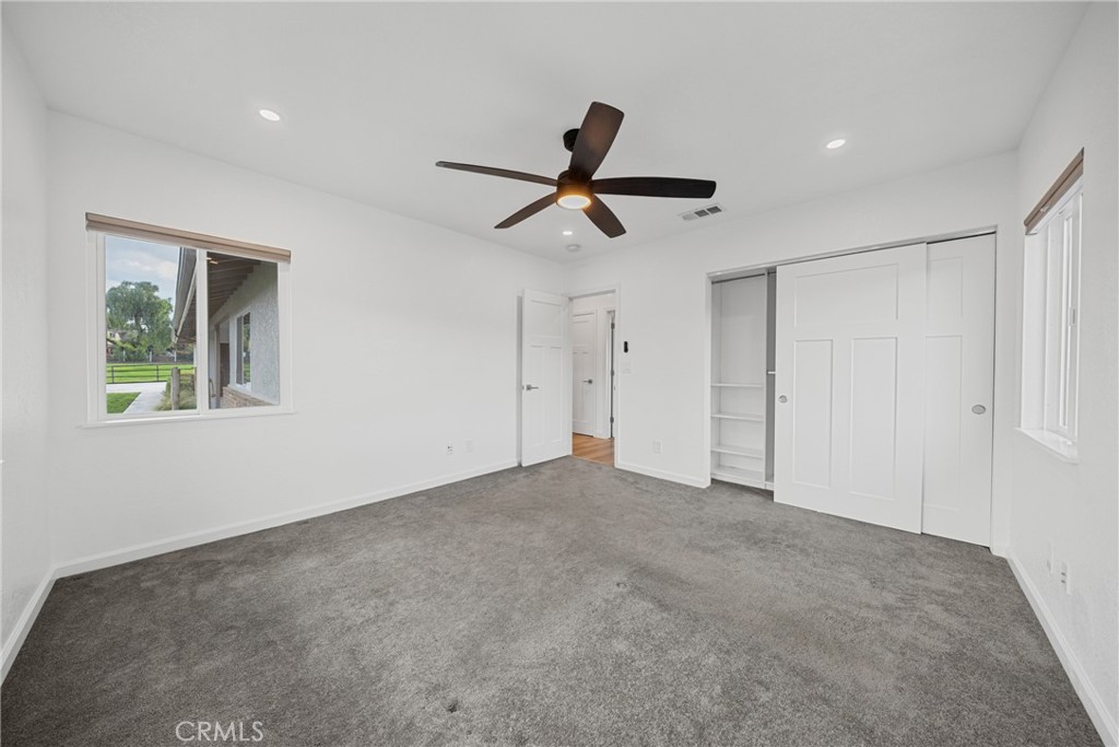 12646 10th Street Yucaipa, CA 92399 - Photo 27 of 72 a view of a livingroom with a ceiling fan and window