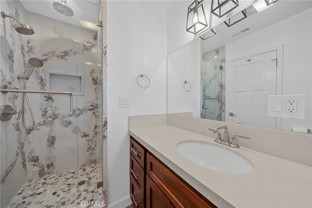12646 10th Street Yucaipa, CA 92399 - Photo 32 of 72 a bathroom with a sink and a mirror
