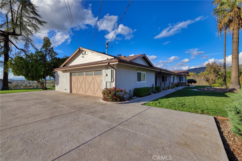 12646 10th Street Yucaipa, CA 92399 - Photo 54 of 72 a view of a house with a yard and large tree
