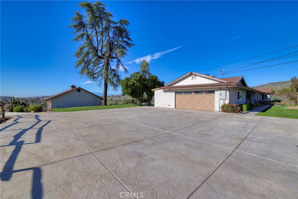 12646 10th Street Yucaipa, CA 92399 - Photo 56 of 72 a front view of a house with a yard and garage