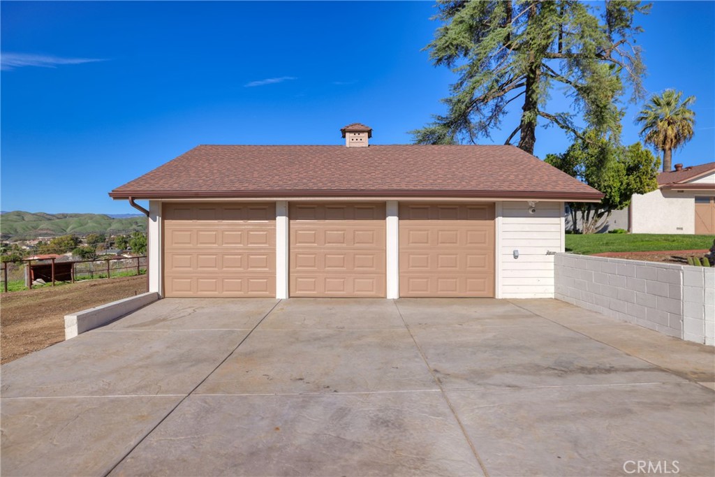 12646 10th Street Yucaipa, CA 92399 - Photo 57 of 72 a view of a house with a yard and garage