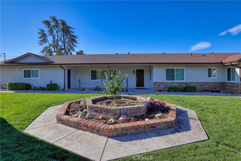 12646 10th Street Yucaipa, CA 92399 - Photo 60 of 72 a view of a house with a swimming pool and a yard
