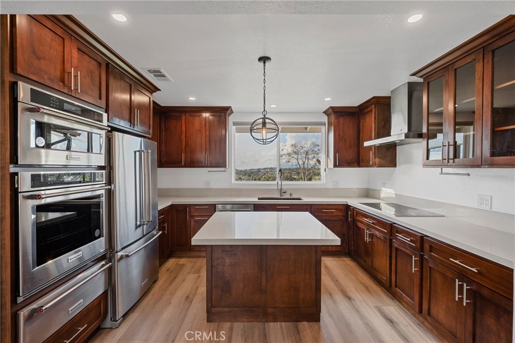 12646 10th Street Yucaipa, CA 92399 - Photo 6 of 72 a kitchen with stainless steel appliances granite countertop a stove a sink dishwasher and microwave oven with cabinets
