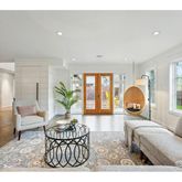a living room with furniture a window and a potted plant