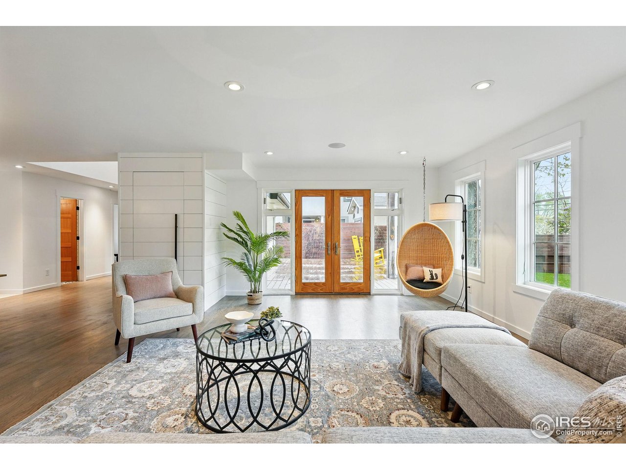a living room with furniture a window and a potted plant