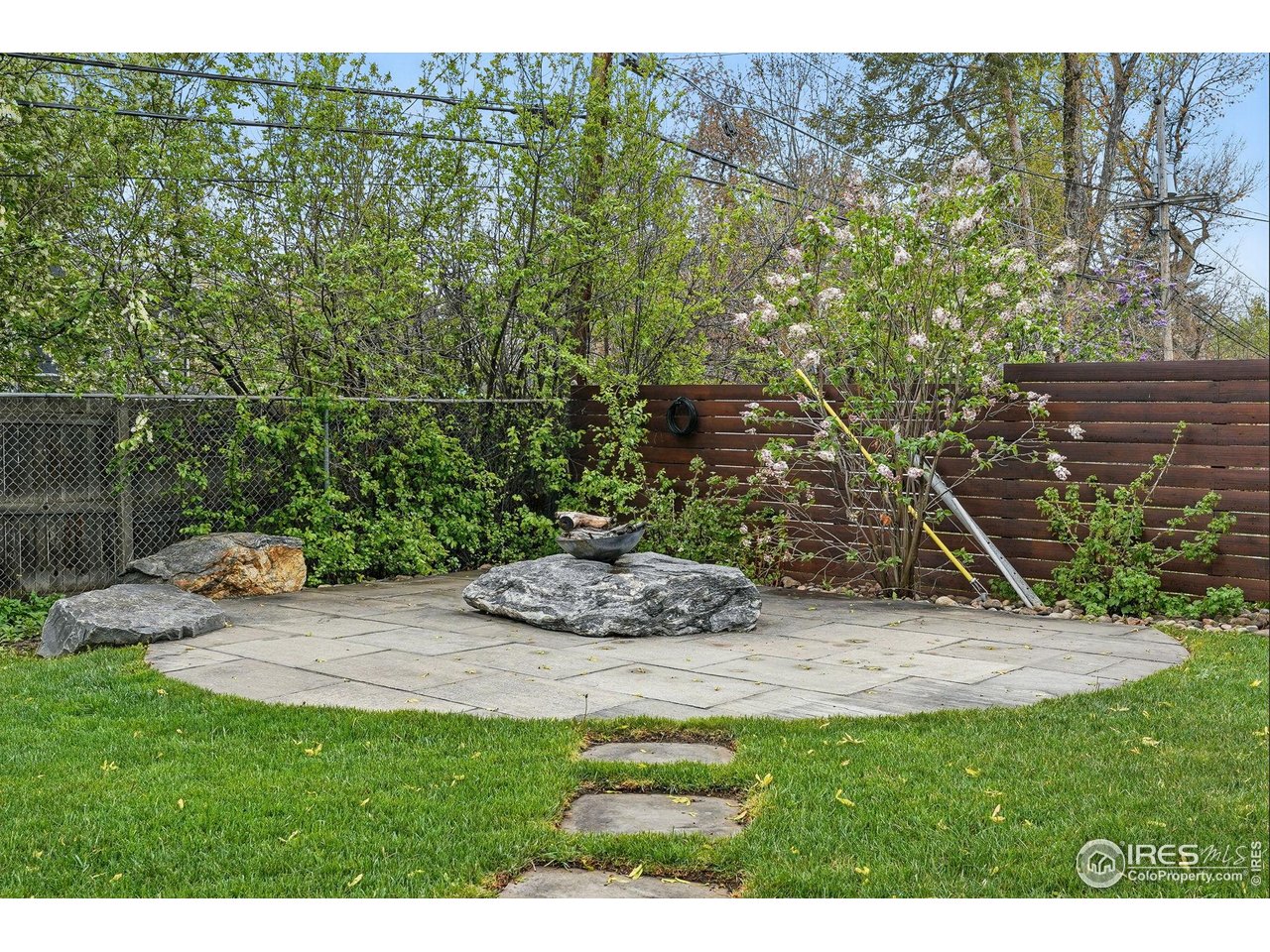 2970 21st Street Boulder, CO 80304 - Photo 15 of 33 a view of a backyard with plants and a bench