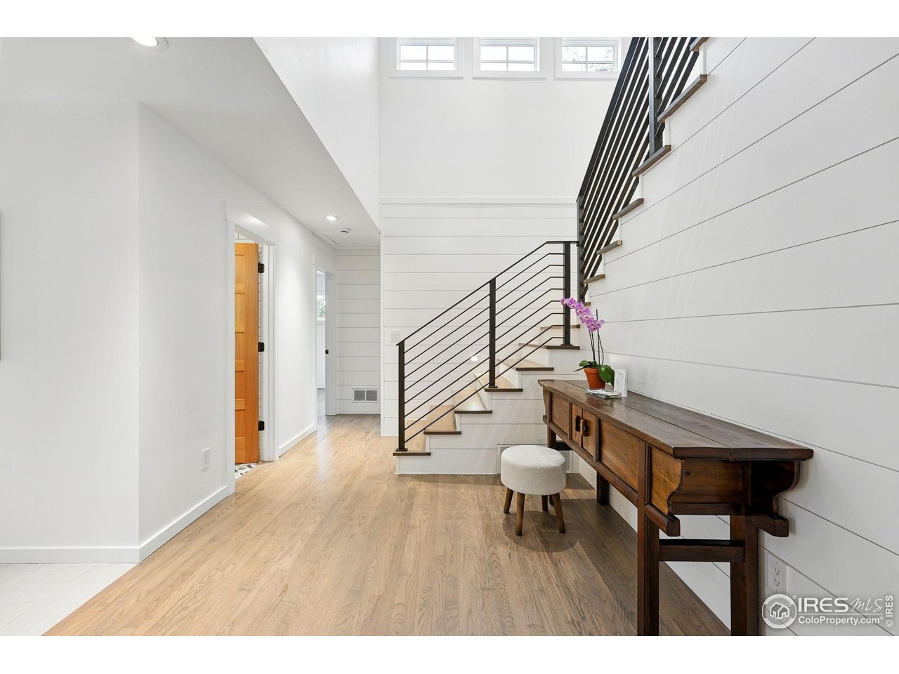 2970 21st Street Boulder, CO 80304 - Photo 18 of 33 a hallway with wooden floor table and chairs