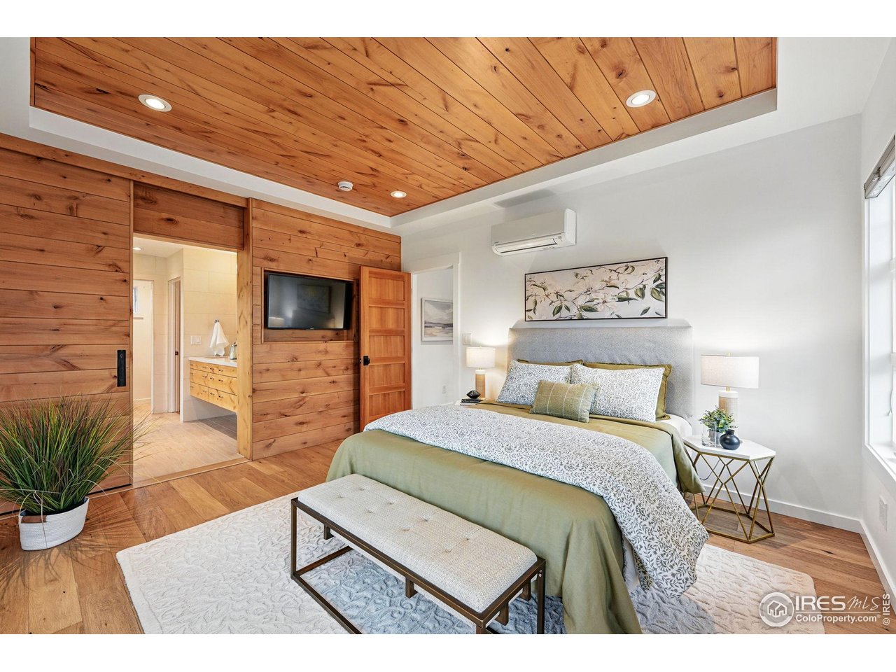 2970 21st Street Boulder, CO 80304 - Photo 20 of 33 a bedroom with a bed and a flat screen tv