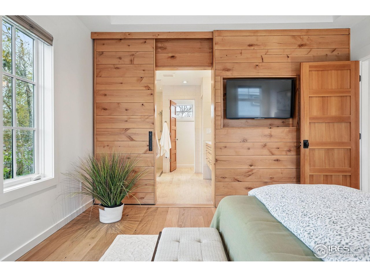2970 21st Street Boulder, CO 80304 - Photo 21 of 33 a hallway with a couch and a stove with wooden floor