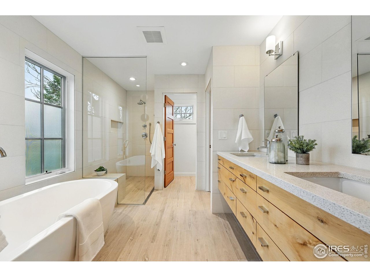 2970 21st Street Boulder, CO 80304 - Photo 23 of 33 a spacious bathroom with a double vanity sink a large mirror and shower