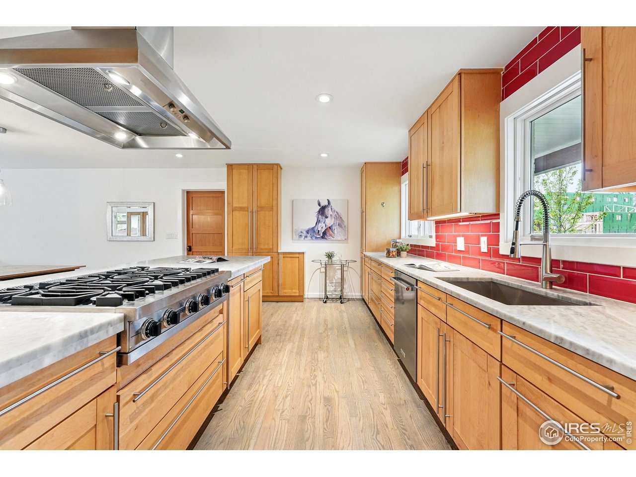 2970 21st Street Boulder, CO 80304 - Photo 7 of 33 a large kitchen with stainless steel appliances granite countertop a lot of counter space and wooden floors