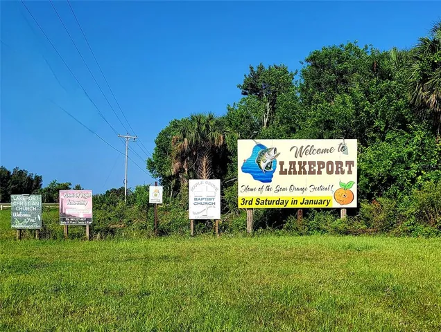 a sign on the side of the green field