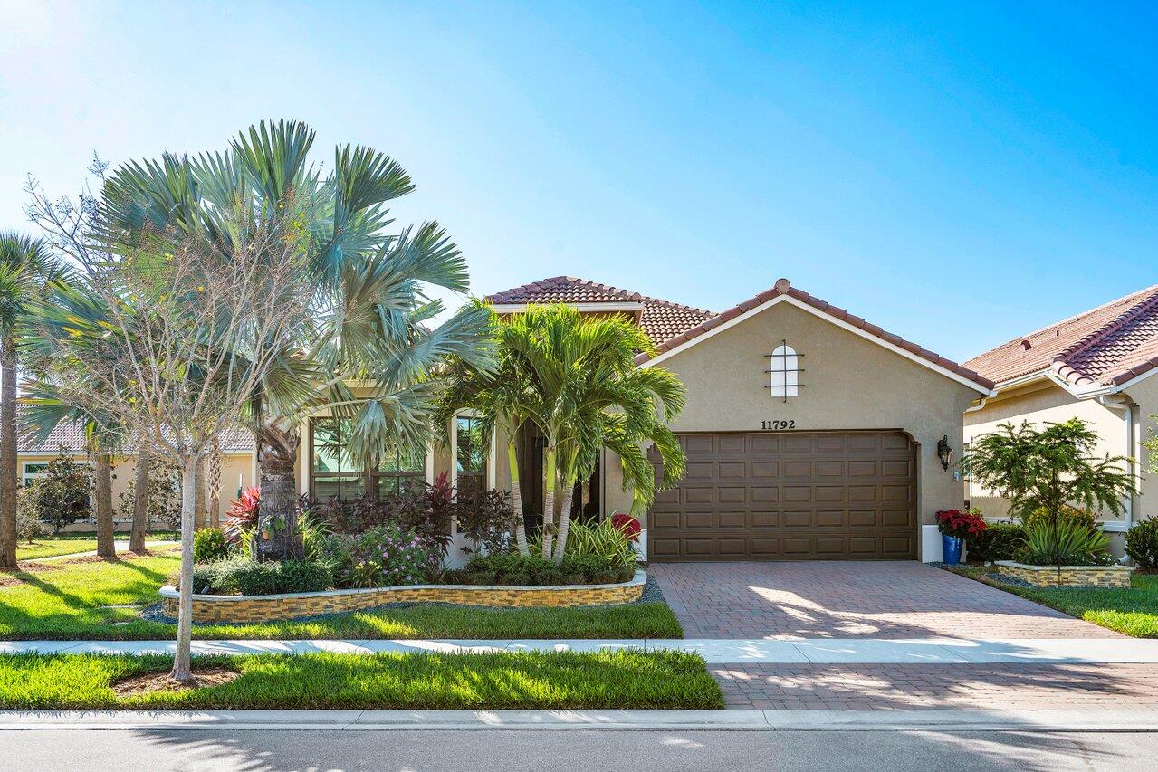 11792 Leon Circle Parkland, FL 33076 - Photo 1 of 51 a front view of a house with a yard