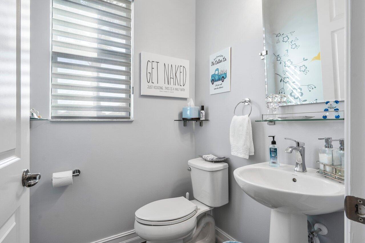 11792 Leon Circle Parkland, FL 33076 - Photo 12 of 51 a bathroom with a toilet sink and mirror