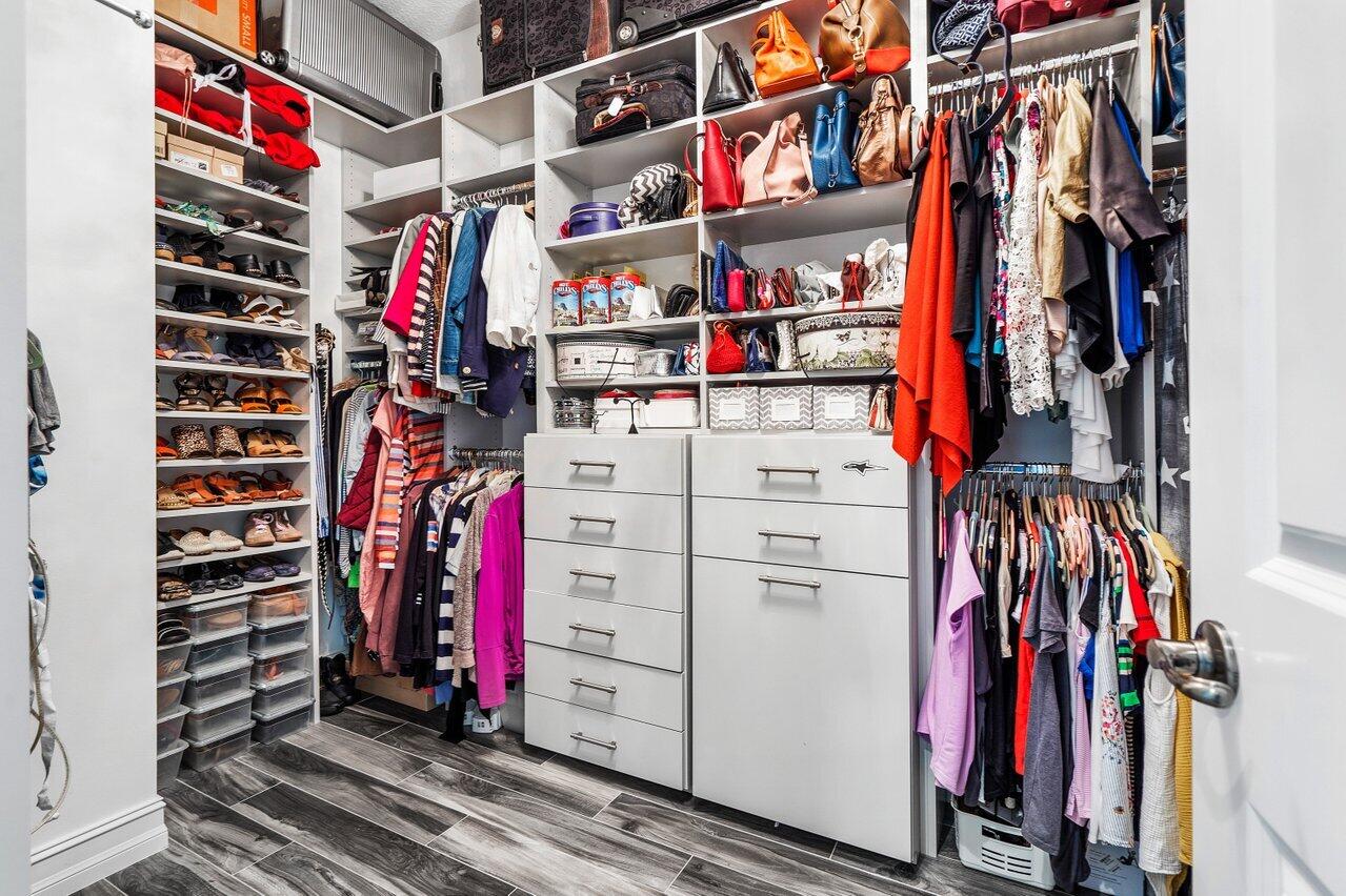 11792 Leon Circle Parkland, FL 33076 - Photo 17 of 51 a view of walk in closet with clothes and shoes
