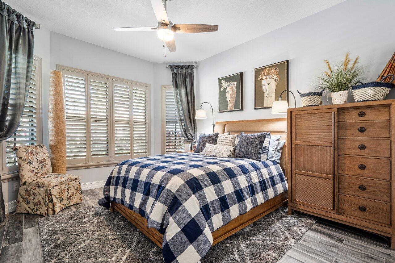 11792 Leon Circle Parkland, FL 33076 - Photo 18 of 51 a bedroom with a large bed and windows