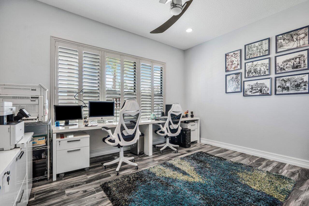 11792 Leon Circle Parkland, FL 33076 - Photo 20 of 51 a view of a workspace with furniture and a window