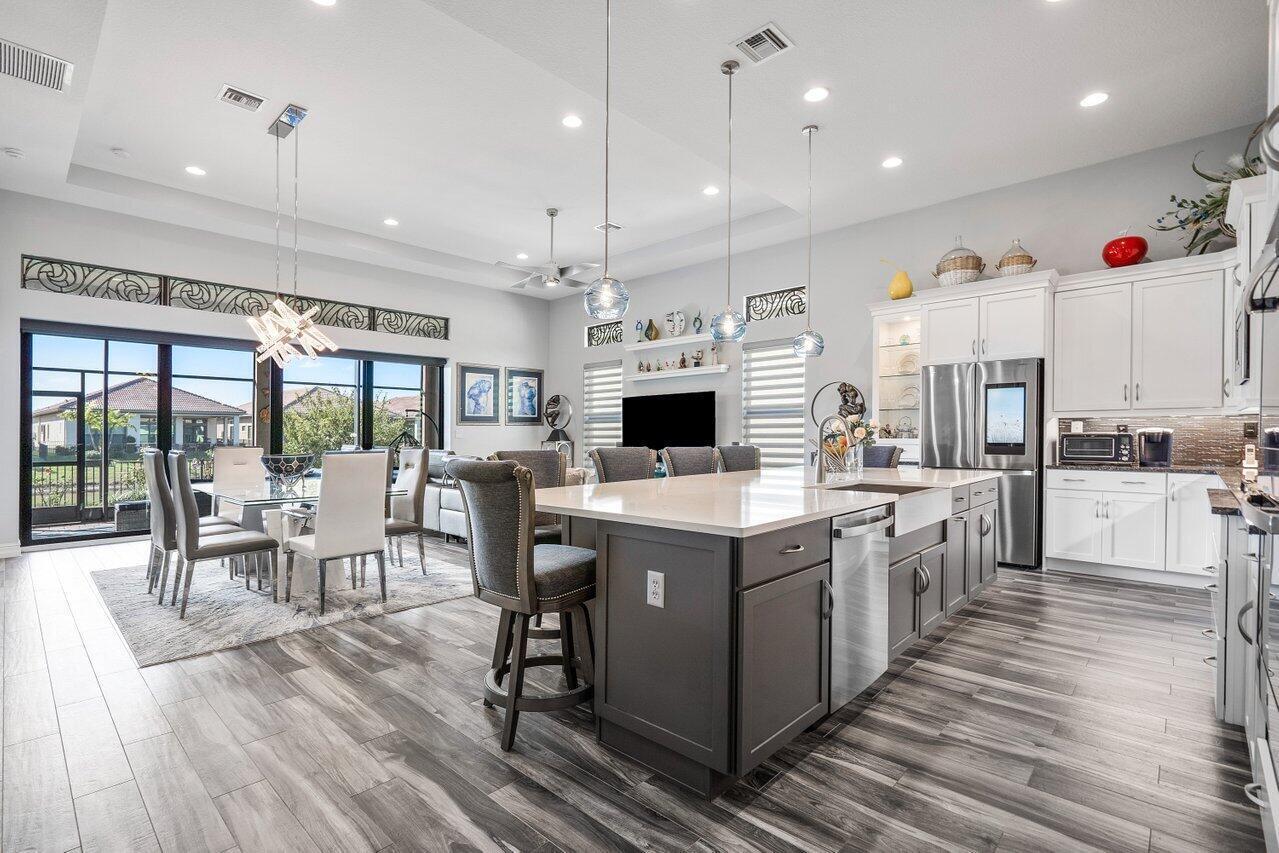 11792 Leon Circle Parkland, FL 33076 - Photo 2 of 51 a large kitchen with lots of counter space a sink appliances and cabinets