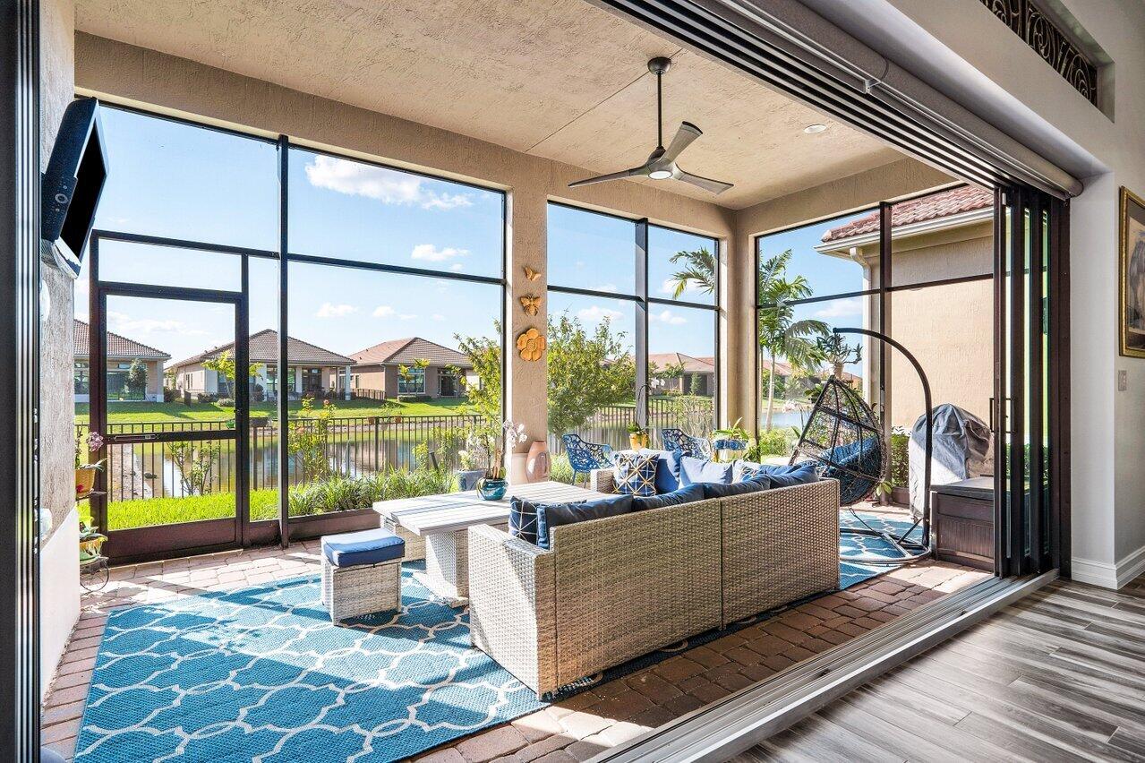 11792 Leon Circle Parkland, FL 33076 - Photo 22 of 51 a living room with large windows