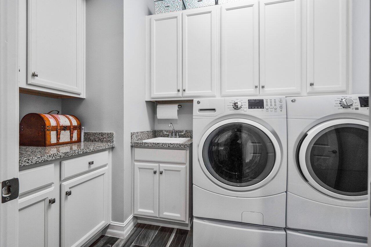 11792 Leon Circle Parkland, FL 33076 - Photo 29 of 51 a kitchen with white cabinets and white appliances