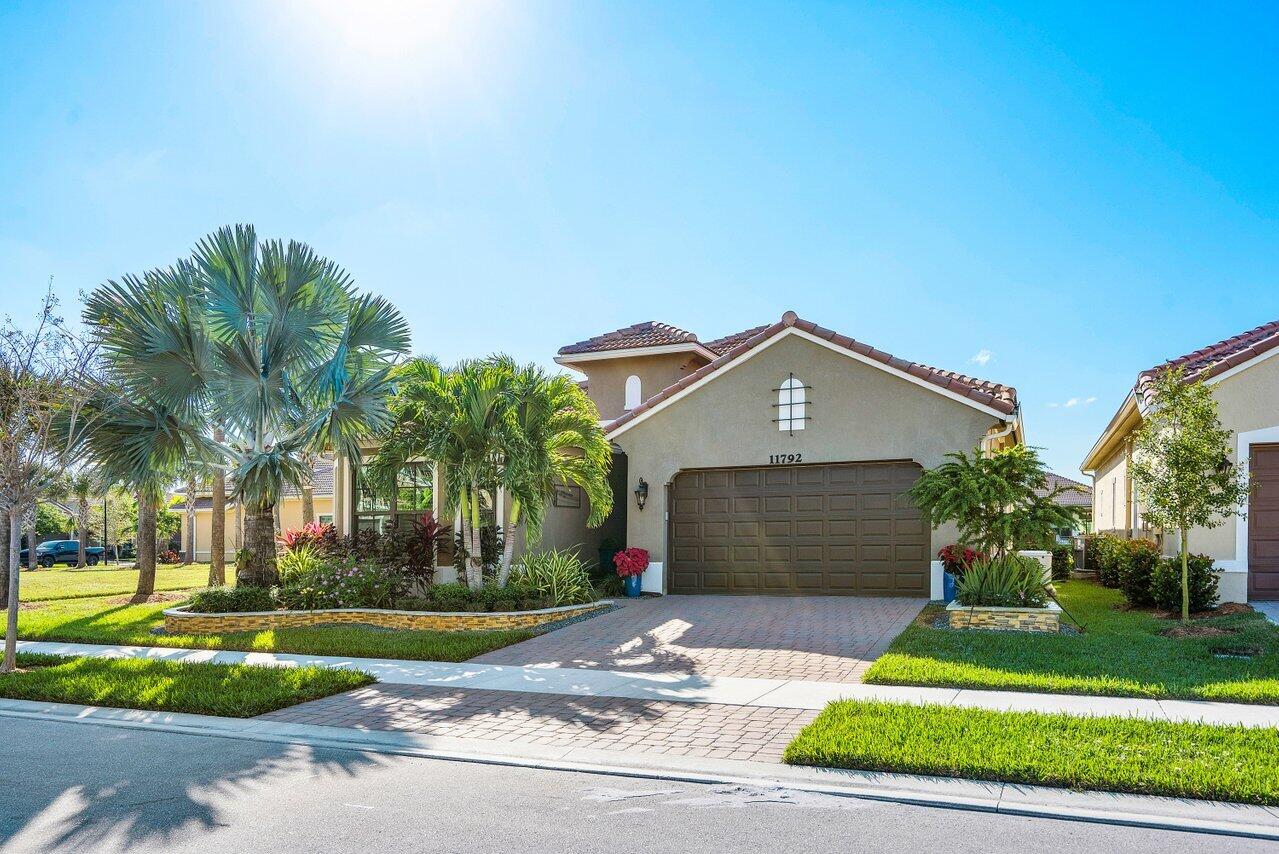 11792 Leon Circle Parkland, FL 33076 - Photo 38 of 51 a front view of a house with a yard and garage