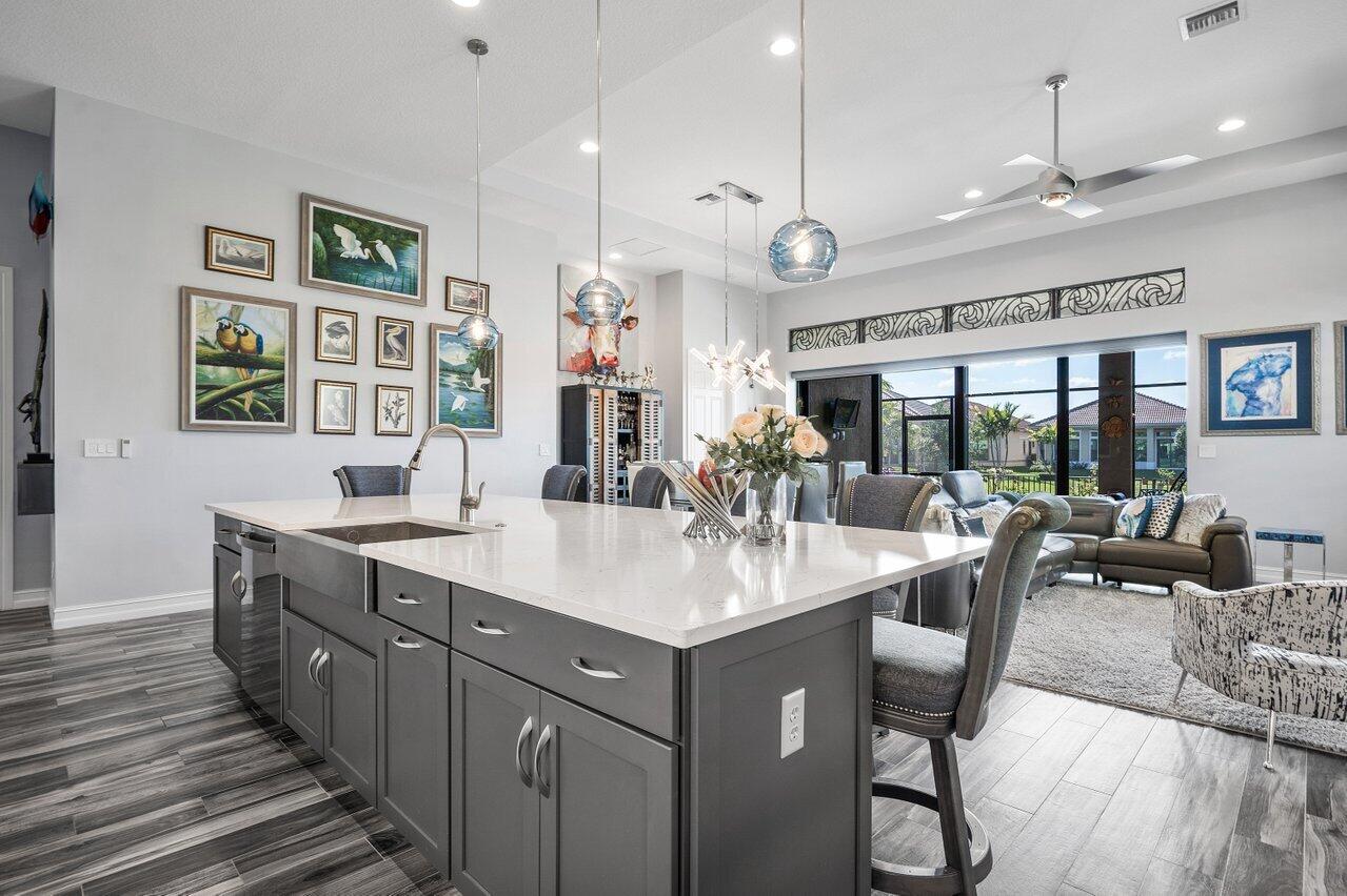 11792 Leon Circle Parkland, FL 33076 - Photo 9 of 51 a large kitchen with a counter space a sink appliances and living room view